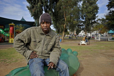 A Sudanese man, who illegally arrived in Israel in search of asylum three years earlier, hangs out at Levinsky Garden, a place that serves as a meeting place and as a pool of cheap workers.