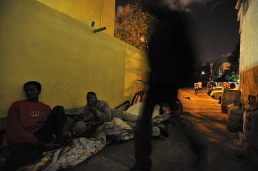 Eritrean asylum seekers prepare for a nights sleep outside their temporary shelter.