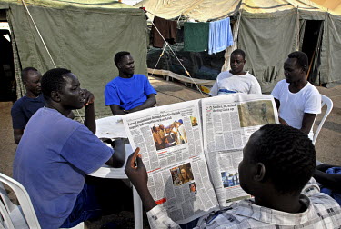 Men sit together near their tents in a special detention facility within Ketziot Prison compound, designated for African asylum seekers who have illegally crossed the nearby Egyptian border into Israe...