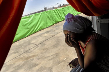 An Eritrean woman at the window of her caravan room, in a special detention facility within Ketziot Prison compound, designated for African asylum seekers who have illegally crossed the nearby Egyptia...
