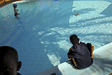 Sudanese children and an Israeli child enjoy the pool in a hotel. The hotel was financed by the Israeli government as a temporary solution, after immigrants had illegally crossed the Egyptian border i...