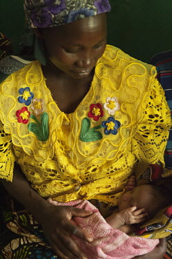 A woman holds her newborn baby.