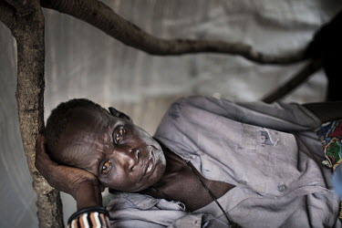 An elderly man lies in his makeshift shelter in Jammam refugee camp. More than 500,000 people have fled from Sudan into South Sudan as a result of the ongoing conflict between the two states.