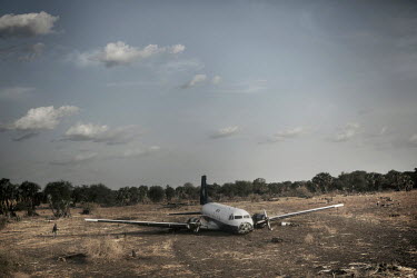 A stricken aeroplane lies, where it crash-landed, at the end of the Maban airstrip.