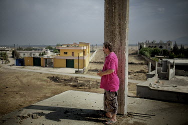A Syrian refugee stands on a rooftop looking toward the border of his home. Approximately 30,000 people, 80% women and children, have fled from Syria to Lebanon since the conflict started. Protests ag...