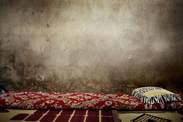 Bedding inside a concrete room where several Syrian women and their children, who have fled over the border to escape the fighting in their homeland, now live. Inside the room summer temperatures regu...