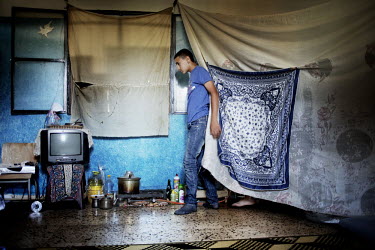 A young boy walks through a room where he now lives with his family. It is just five kilometres from their home, over the border in Syria. They fled the conflict, that claimed the life of one of his b...