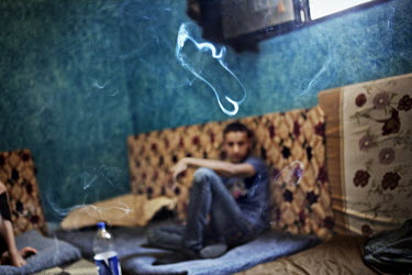 A young boy sits in a room where he now lives with his family. It is just five kilometres from their home, over the border in Syria. They fled the conflict that claimed the life of one of his brothers...