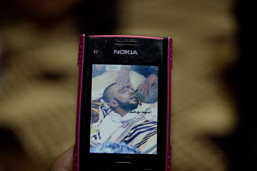 A man holds a mobile phone, displaying a photograph of his dead son, killed during the conflict in Syria. Protests against the ruling Baathist regime of Bashar al-Assad erupted in March 2011. Although...