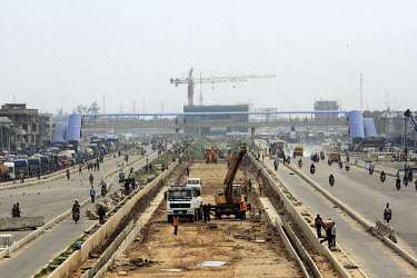 Construction work, taking place among the busy Lagos traffic, on the Orile light rail terminal. This is part of a private/public enterprise to build a mass transit system in the city.