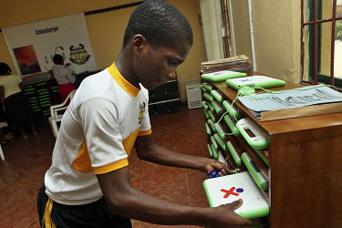 A student gets his stored laptop at the Community Secondary School Rumuomasi as part of the One Laptop per Child (OLPC) project. This seeks 'to create educational opportunities for the world's poorest...