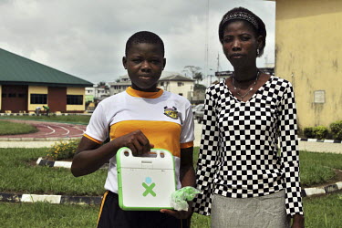 Mercy and her mother Joy Mordi stand together after she received her laptop at the Community Secondary School in Rumuomasi as part of the One Laptop per Child (OLPC) project. This seeks 'to create edu...