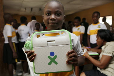 Atayero Ade Jumoke holds up a laptop he has just received at the Community Secondary School Rumuomasi as part of the One Laptop per Child (OLPC) project. This seeks 'to create educational opportunitie...