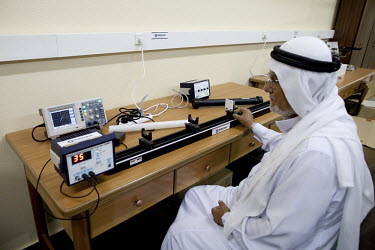 Lecturer of Physics, Mahmoud Abdel Rahman, using equipment in the Optics Laboratory, part of the Physics Department in the Islamic University.