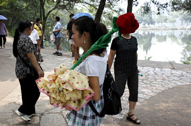 A tour guide holds a rose shaped loud speaker at the birthplace of Mao Zedong in Shaoshan.