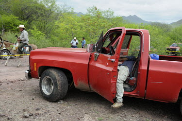 A murder victim lies in his truck, most probably killed because of being involved in narcotics trafficking. In the month of June 2009, approximately three people were killed in Culiacan each day.
