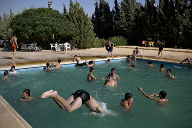 Children play in an open air swimming pool in Mari. The area was later bombed by a Syrian Airforce fighter plane on August 13th. The bombs missed the pool by 20 metres and nobody was injured.