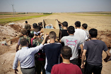 Free Syrian Army (FSA) fighters and family members carry the coffin of Omar Ismail Abdul Rahman (30) who died fighting for the FSA in Salaheddin, Aleppo, to his burial in Tal Rifaat. Omar, a farm boy...