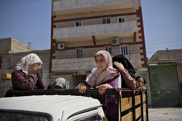 Women flee after a nearby residential home was destroyed by a bomb dropped from a Syrian Airforce fighter jet that was targeting the neighbouring Free Syrian Army (FSA) command centre in Aleppo. Eleve...