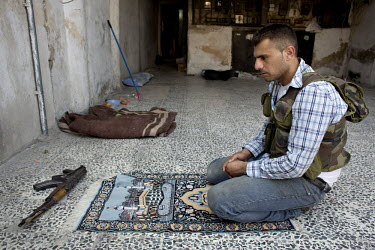 A rebel Free Syrian Army (FSA) fighter prays near the front lines of Salaheddin in Aleppo.