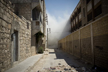 Dust rises from a residential home destroyed by a bomb dropped from a Syrian Airforce fighter jet that was targeting the neighbouring Free Syrian Army (FSA) command centre in Aleppo. Eleven civilians...