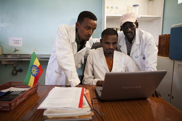 (L -R) Dr Gurara Megerssa, Dr Klubi Zeklude, and Debesso Adune look at test results on a laptop, in Yabello Regional Veterinary Laboratory. Testing is free but if samples test positive for diseases th...