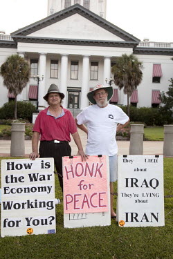 Tom Baxter, a 65 year old Vietnam veteran, accompanied by fellow protestor, Michael Weddington. Every Sunday and Thursday, Baxter protests against the U.S.'s ongoing wars in front of Florida's state c...