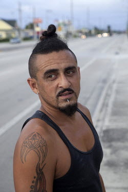 Enrique Qomani, originally from Puerto Rico via New York. He is an auto body shop repair worker in West Palm Beach, Florida. Talking about the upcoming presidential election: 'I don't really pay much...
