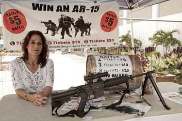 Diana Burns at her stand outside the West Palm Beach, Florida gun show raffling an AR-15 semi-automatic rifle to support her charity 'Dream Hunts for Heroes' which organizes hunting trips for physical...