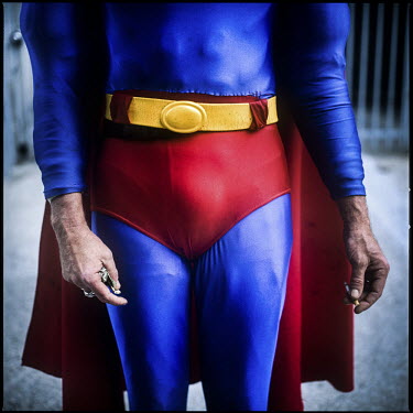 45 year old Christopher Dennis smokes and holds tips as he poses in a Superman costume on Hollywood Boulevard. He has been entertaining tourists, posing for photographs with them for the last 19 years...