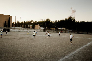Workers from the Ilva steel plant play a game of football. The football pitch is less than 800m away from the deadly polluting chimneys of the Ilva Steel works.