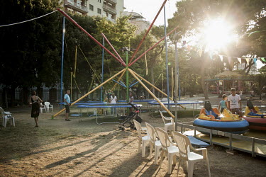 Children and familes play in the central park of Taranto on a summers evening.