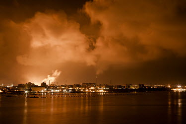 Smoke and fire from one of the seven blast furnaces of the steel plant lights up the night sky over the Tamburi district of the southern Italian town of Taranto.