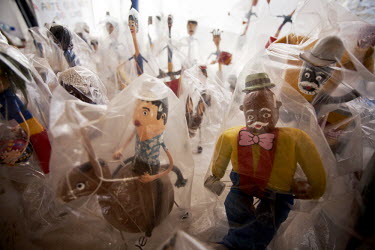 Sculptures made of recycled materials representing Olinda's famous carnival characters for sale in a souvenir shop.