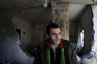 Dr Rami, who lived in Leicester in the UK until recently, in the ruins of the upper floors of the hospital where he works in Salma near the front line between the Free Syrian Army and government force...
