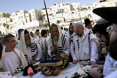 Jewish men gather around the Torah during ceremonies for the' Blessing of the Priests', or 'Birkat Cohanim', at the Western Wall. Thousands of religious Jews travel to Jerusalem during the Jewish holi...
