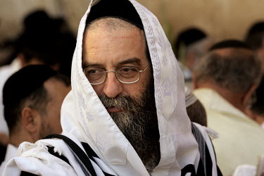 An ultra-orthodox Jew wears a prayer shawl during ceremonies for the 'Blessing of the Priests', or 'Birkat Cohanim' at the Western Wall. Thousands of religious Jews travel to Jerusalem during the Jewi...