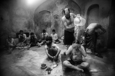 Men and boys bathe in the hot room in a hammam on a Friday after prayers.