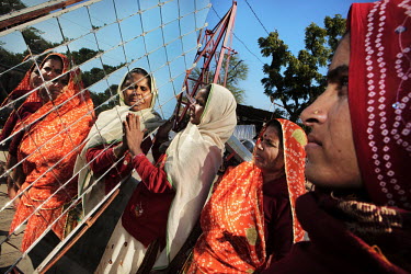 Illiterate and semi-literate women producing parabolic solar cookers. They are members of the Women Barefoot Solar Cooker Engineers Society and received training at the solar powered Barefoot College....