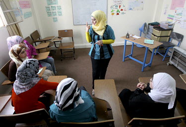 Girls in an English class. The Ramtha facility has been opened by the Government of Jordan to receive Syrian refugees. UNICEF is providing psycho-social support for the children in the vicinity. To da...