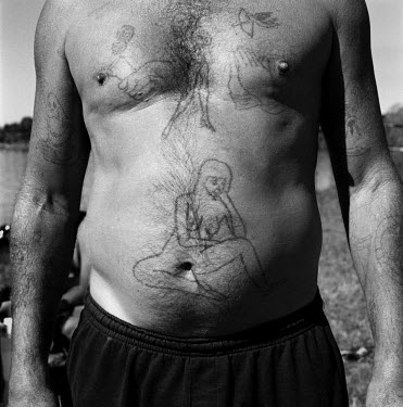 Derrick, displays his tattoos, at Jan Smuts Dam.