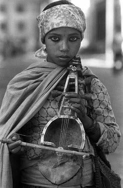 A street musician plays a Sarangui, a type of violin,