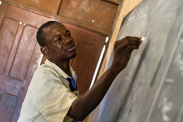 Francis Pii Kugbila teaching a first grade class at Dagliga Primary school near Bolgatanga. When Kugbila became mentally unwell in 2009, his brothers took him to a traditional healer who forced his le...