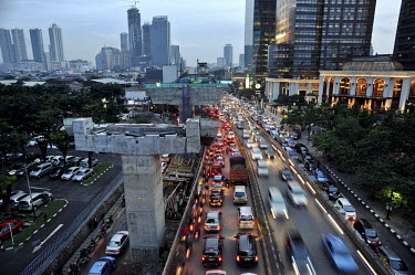 Twilight overview from a new section of elevated road near the main Gen. Sudirman Rd in central Jakarta. With 10-plus million people living in the capital - 25 million, if the Greater Metropolitan are...
