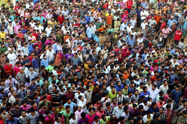 A large crowd of onlookers gathers in front of the collapsed Rana Plaza complex in Savar. The 8 storey building, which housed a number of garment factories employing over 3,000 workers, collapsed on 2...