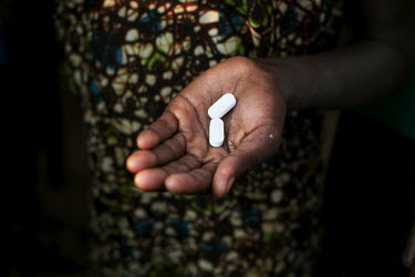 A woman holds some of the drugs she needs to take in order to combat a number of so-called 'neglected tropical diseases' common in the area that she lives. In every village of Bururi, Rutana, Cibitoke...