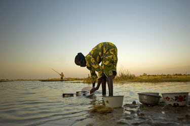 A woman washes pots and pans in the Niger River in the town of Gao.