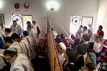 Men and women, segregated by sex, during a service at a synagogue. They belong to a community, one of many worldwide, of so-called 'lost Jews'. These groups, often previously Christians, claim a histo...
