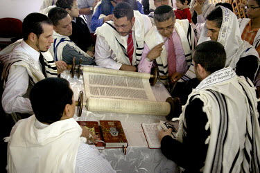A Jewish congregation gathers round their Torah, a 120 year old scroll written in Amsterdam and obtained by the community five years ago. They belong to a community, one of many worldwide, of so-calle...