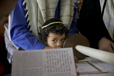 Four year old Baruj Cano watches as his father and other men from the Jewish community read from the Torah. They belong to a community, one of many worldwide, of so-called 'lost Jews'. These communiti...